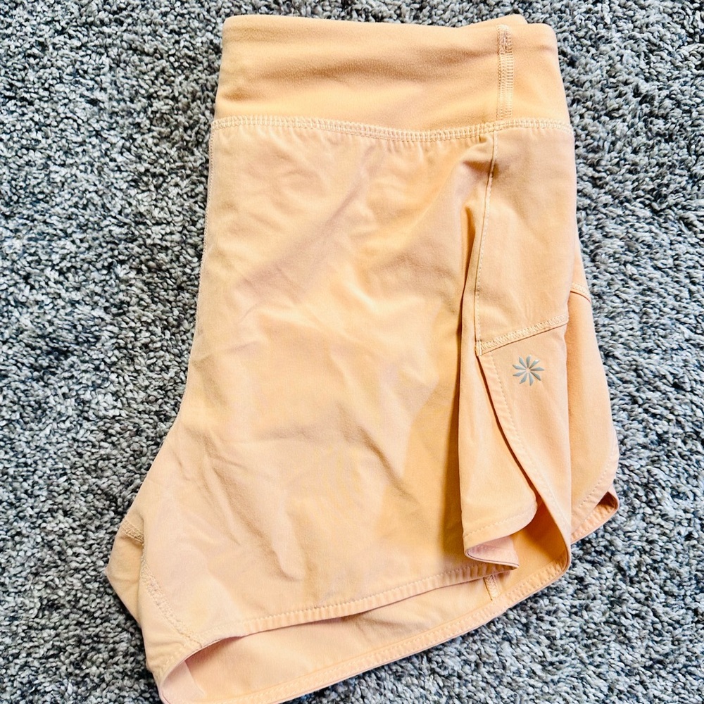 Athleta Girl in bright peach.